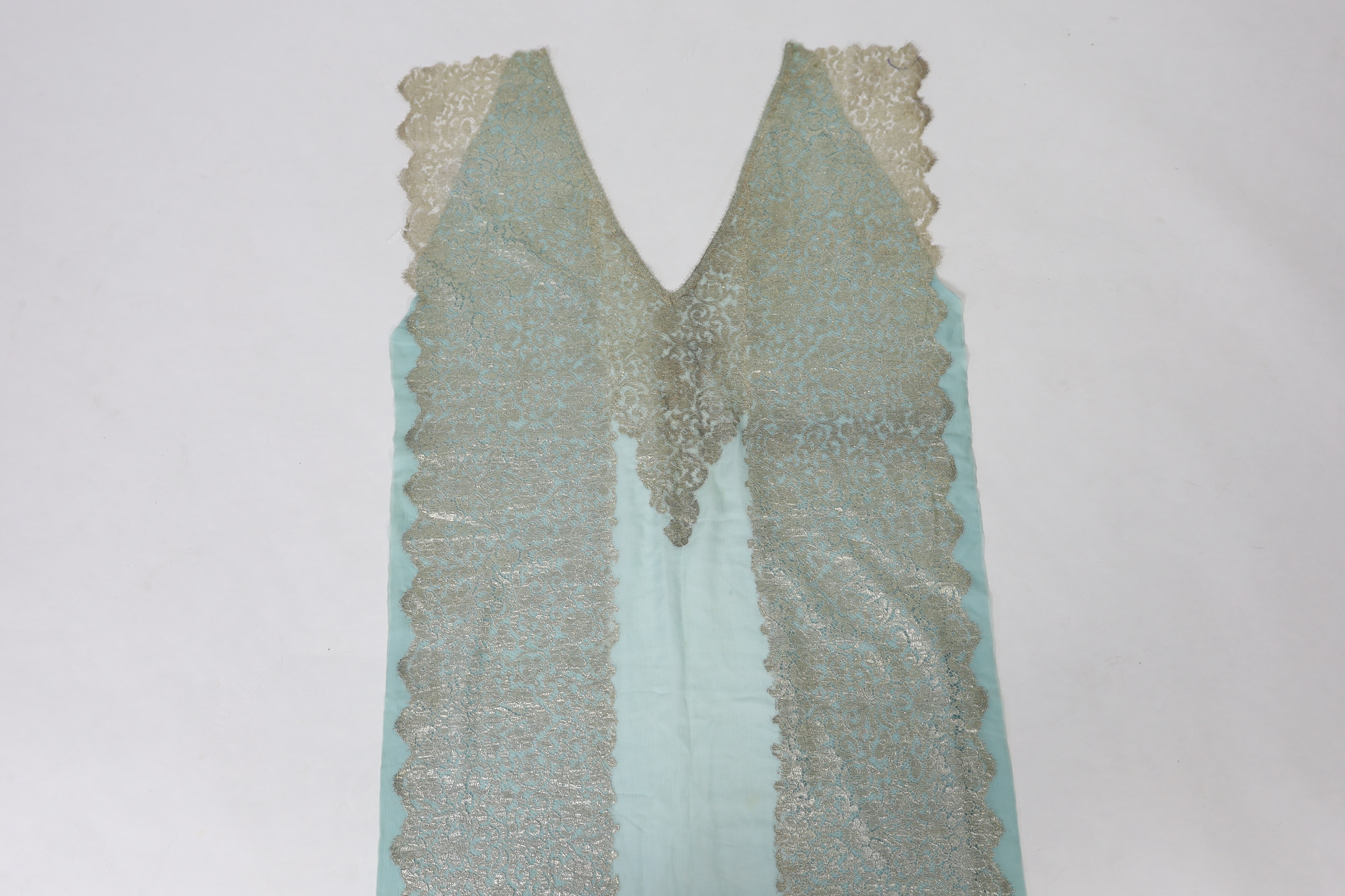 A 1920's silver machine lace and chiffon train, to an evening dress, the silver lace has been cut and appliquéd onto the turquoise chiffon, 209cm long